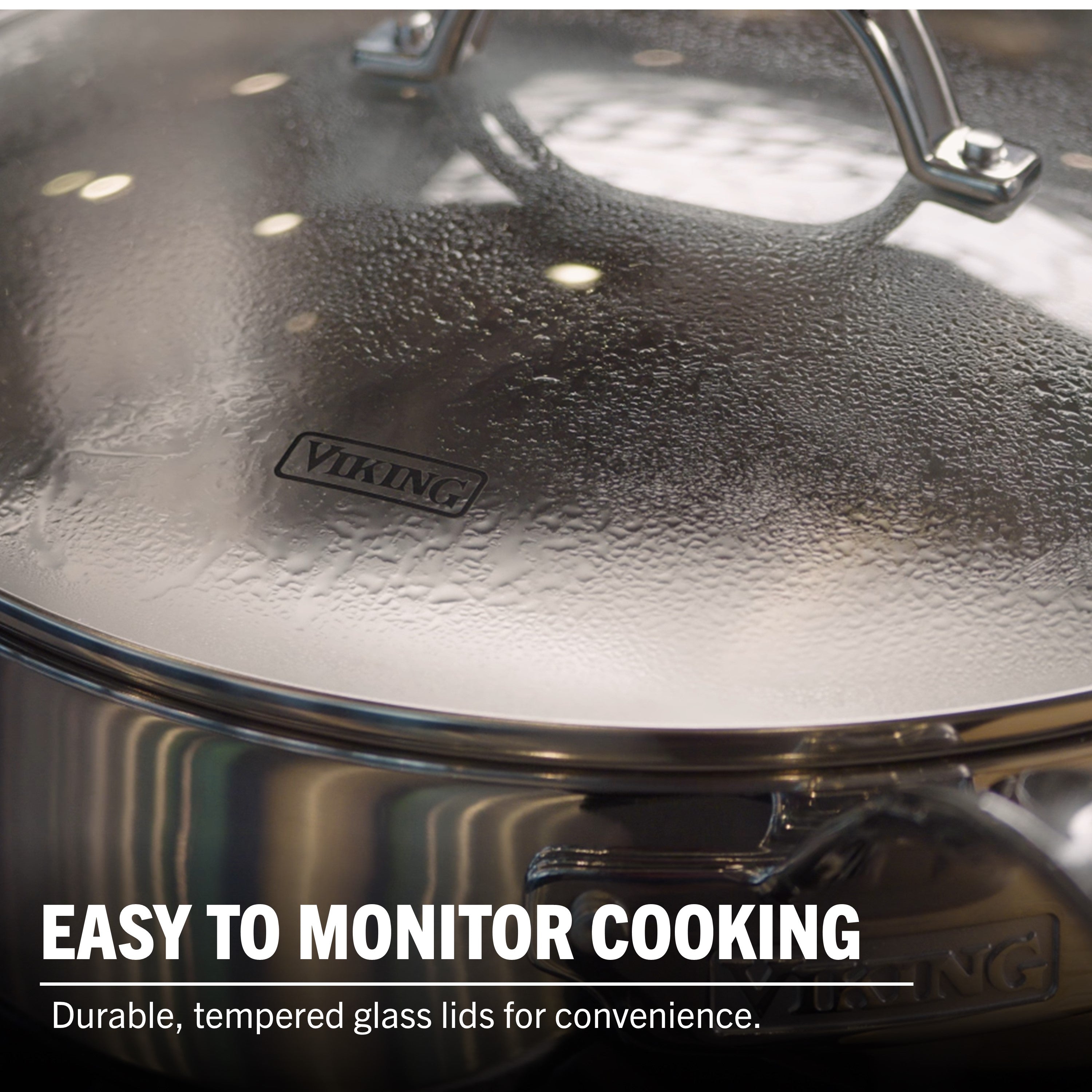 A close-up of Viking 3-Ply Stainless Steel 13-Piece Cookware Set from Viking Culinary Products with a durable, tempered glass lid covered in condensation. The text on the image reads: EASY TO MONITOR COOKING with convenient glass lids.