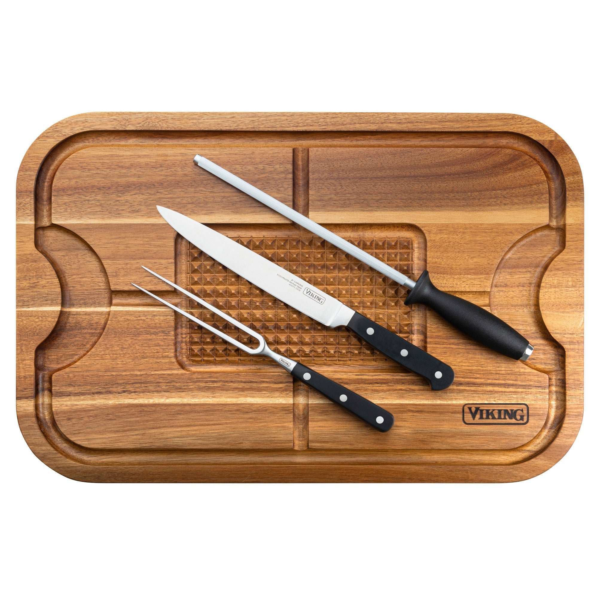 The Viking Culinary Products Acacia Wood Cutting Board comes with a 3-piece stainless steel carving set—knife, meat fork, and sharpening rod—all with black handles and convenient juice grooves.