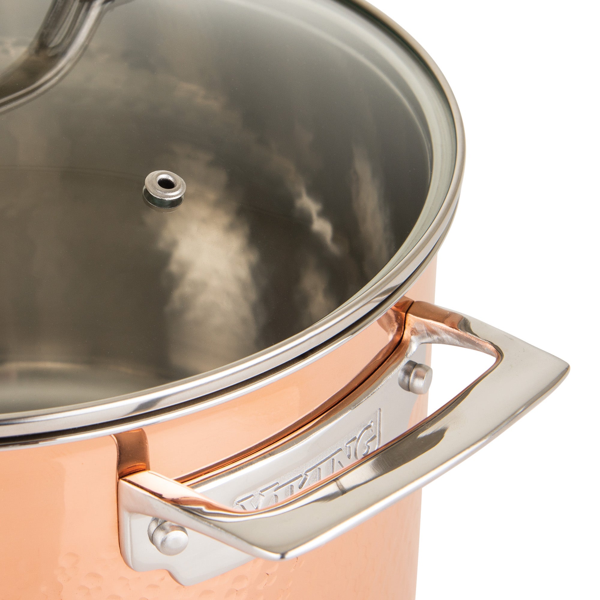 Close-up of Viking 3-Ply Hammered Copper Clad 10-Piece Cookware Set by Viking Culinary Products, showing a shiny handle with embossed brand name, glass lid with steam vent, and stainless steel interior reflecting light.