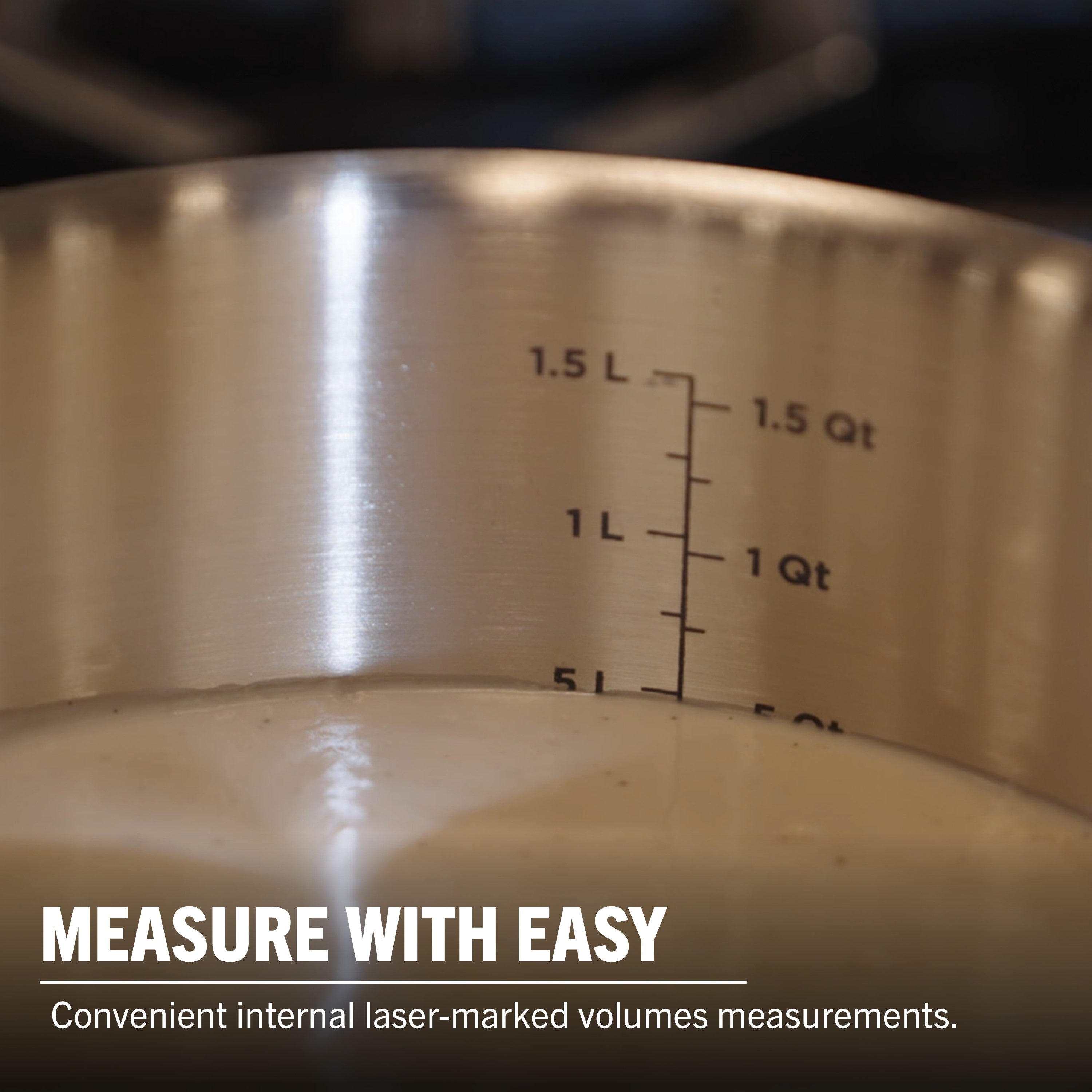A close-up of the Viking 3-Ply Stainless Steel 13-Piece Cookware Set with Glass Lids by Viking Culinary Products, featuring induction compatibility, internal laser-marked volume measurements in liters and quarts, and durable 3-ply construction.
