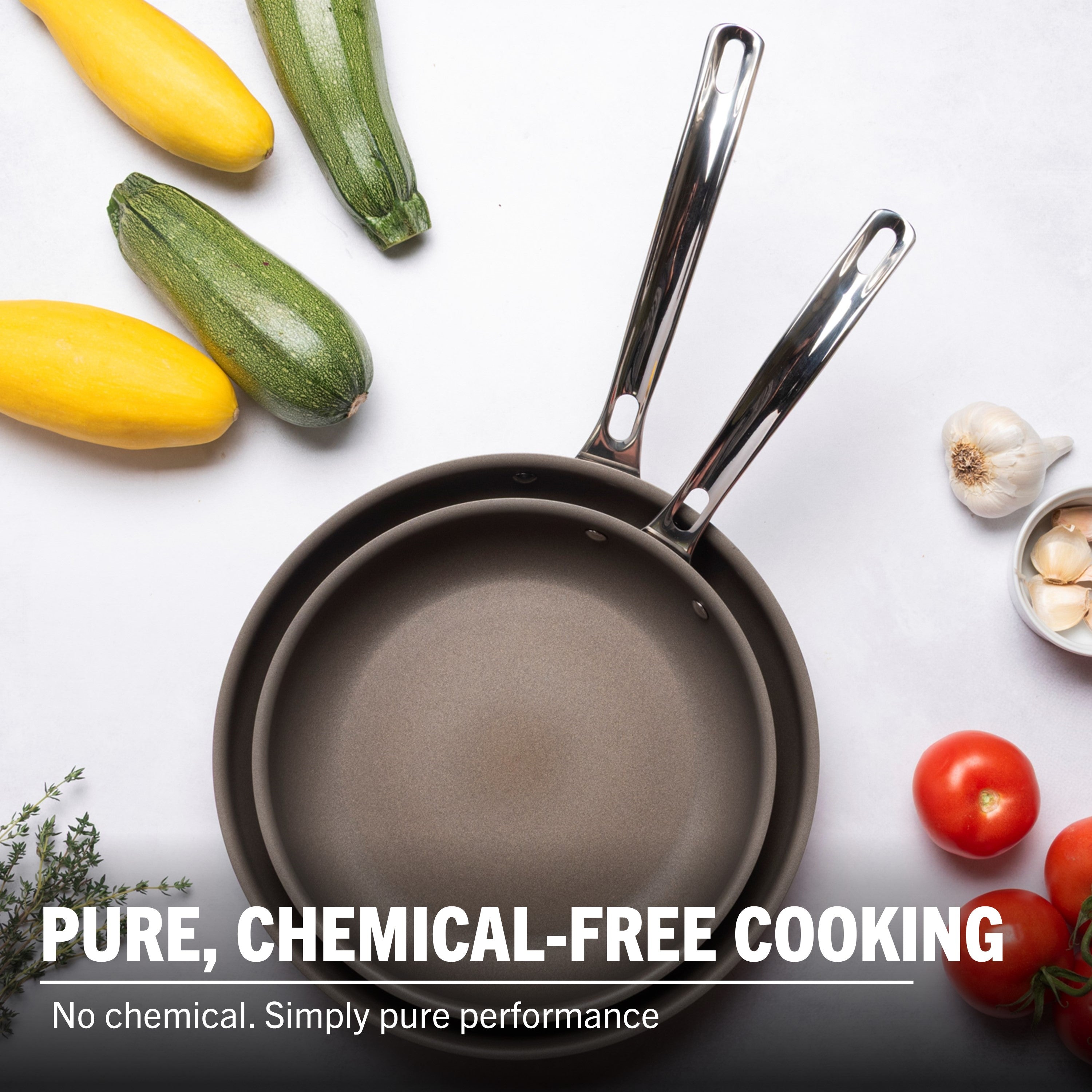 The Viking PureGlide Pro 3-Ply 2-Piece Fry Pan Set (9.5" & 11") by Viking Culinary Products sits on a white surface with fresh veggies. Text: Healthy cooking, no chemicals—simply pure performance with nonstick fry pans.
