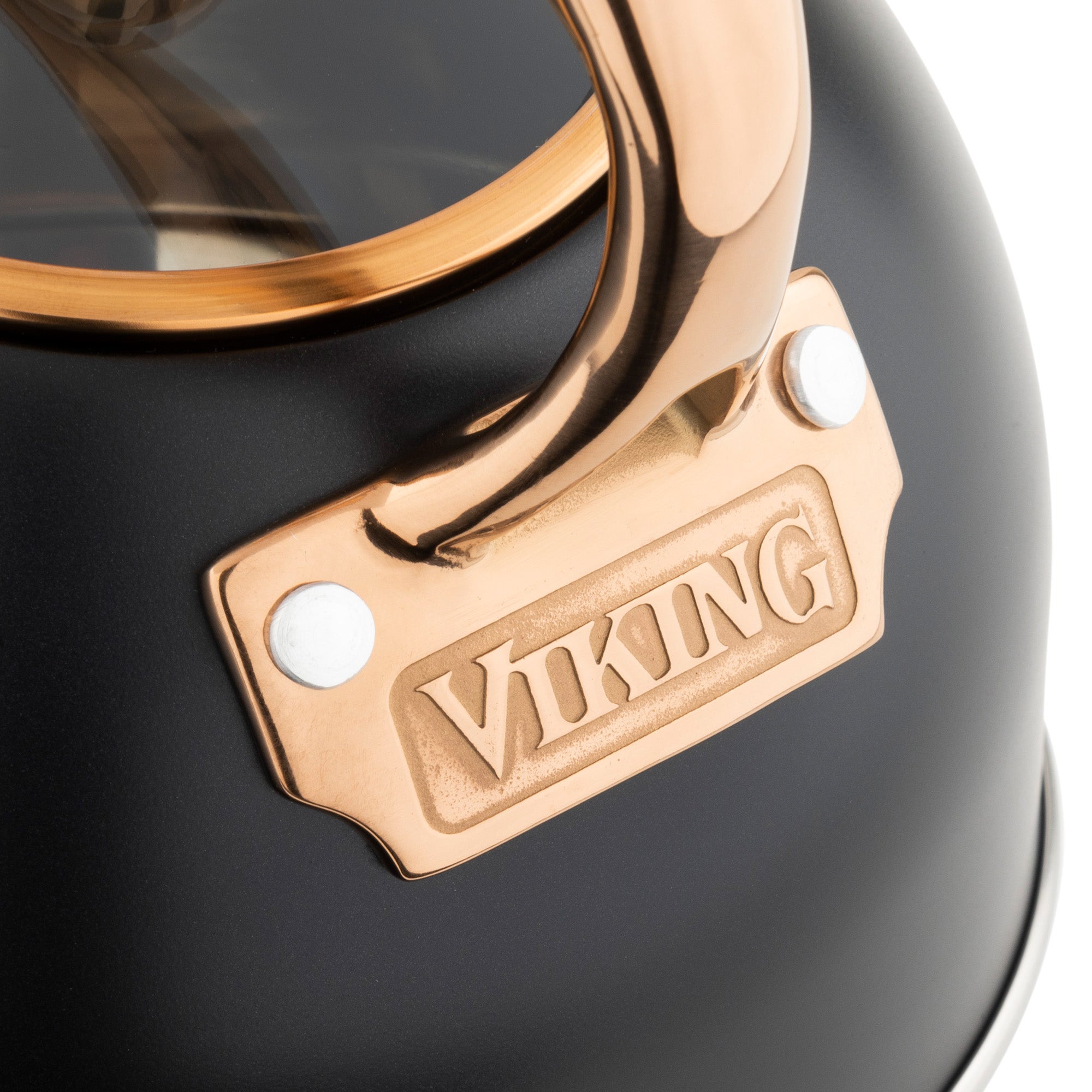 Close-up of the Viking 2.6-Quart Matte Black and Copper Stainless Steel Whistling Kettle by Viking Culinary Products, featuring a 3-ply base for induction stovetop compatibility.