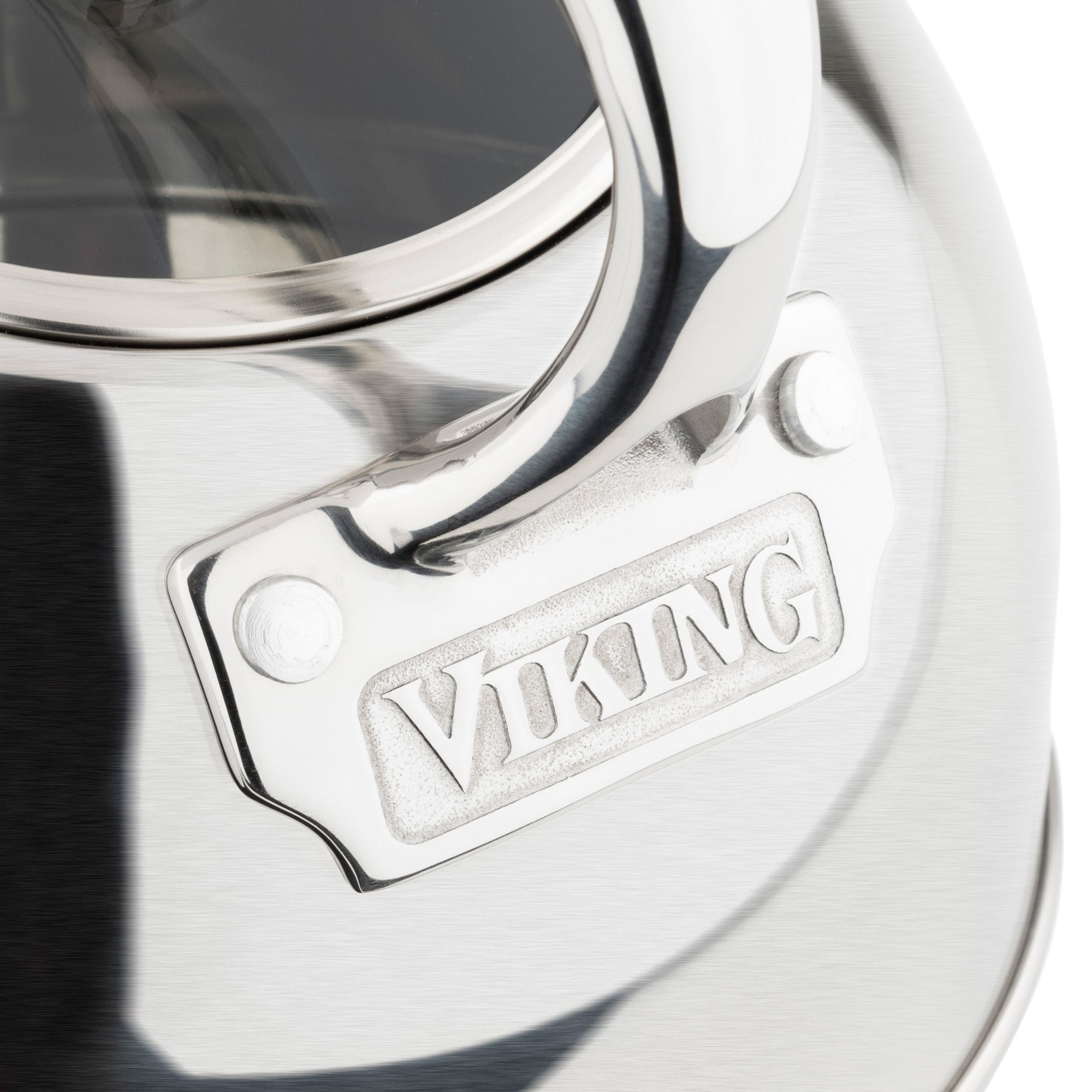 Close-up of the Viking Culinary Products 2.6-Quart Satin Finish Stainless Steel Whistling Kettle, featuring a handle, engraved logo on a side metal plate, and an induction-compatible 3-ply base.