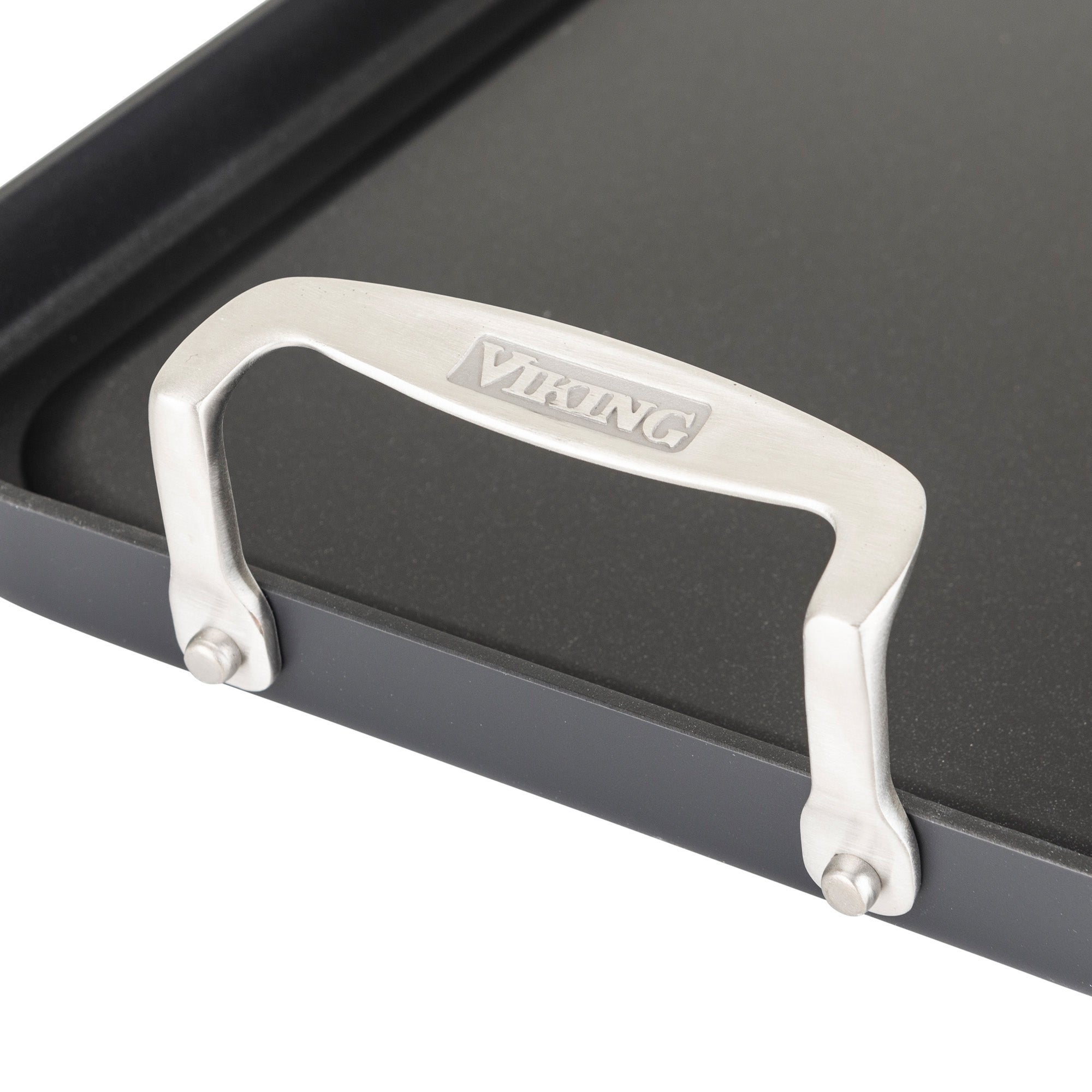 Close-up of a metal handle with the Viking Culinary Products logo, attached to the corner of the Viking Hard Anodized Nonstick Double Burner Griddle.