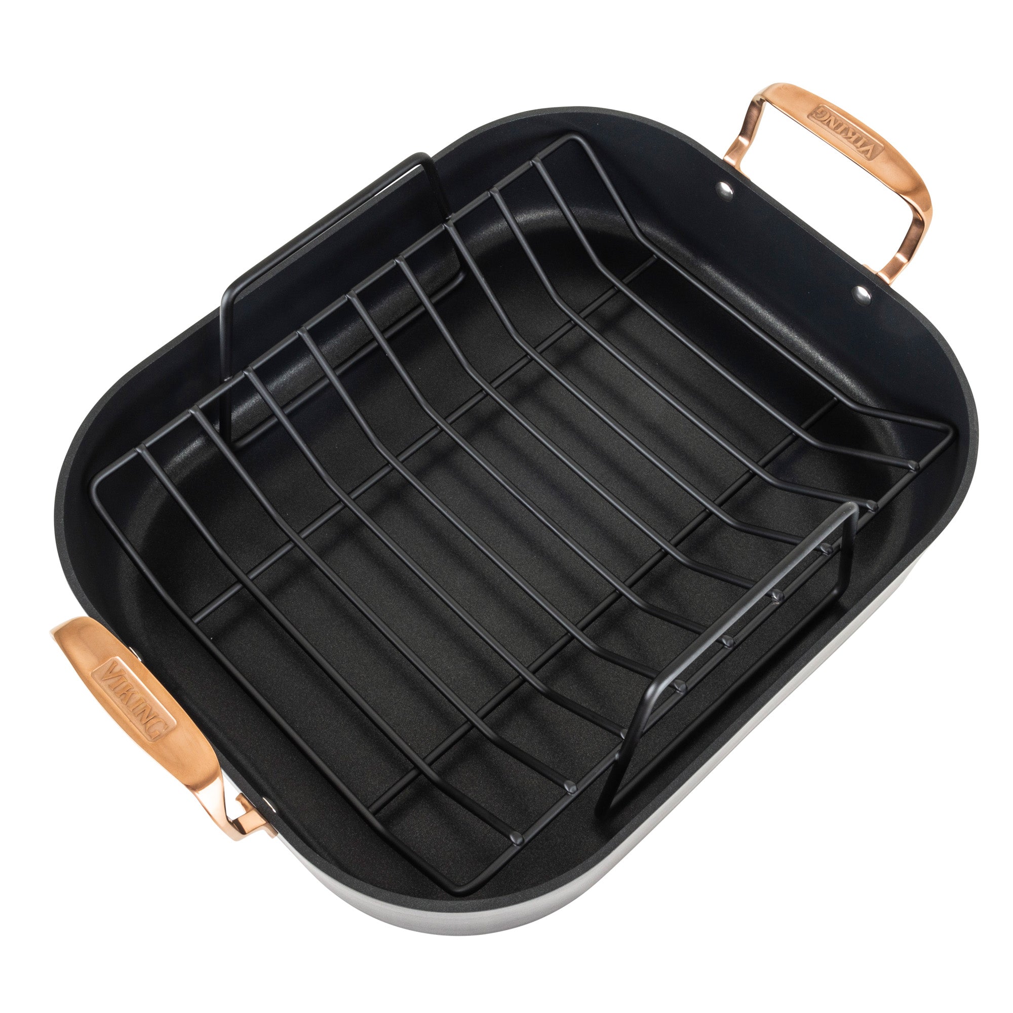 The Viking Hard Anodized Nonstick Roaster by Viking Culinary Products features copper handles, a removable rack, and includes a bonus carving set; its rectangular black aluminum body ensures durability and easy roasting.