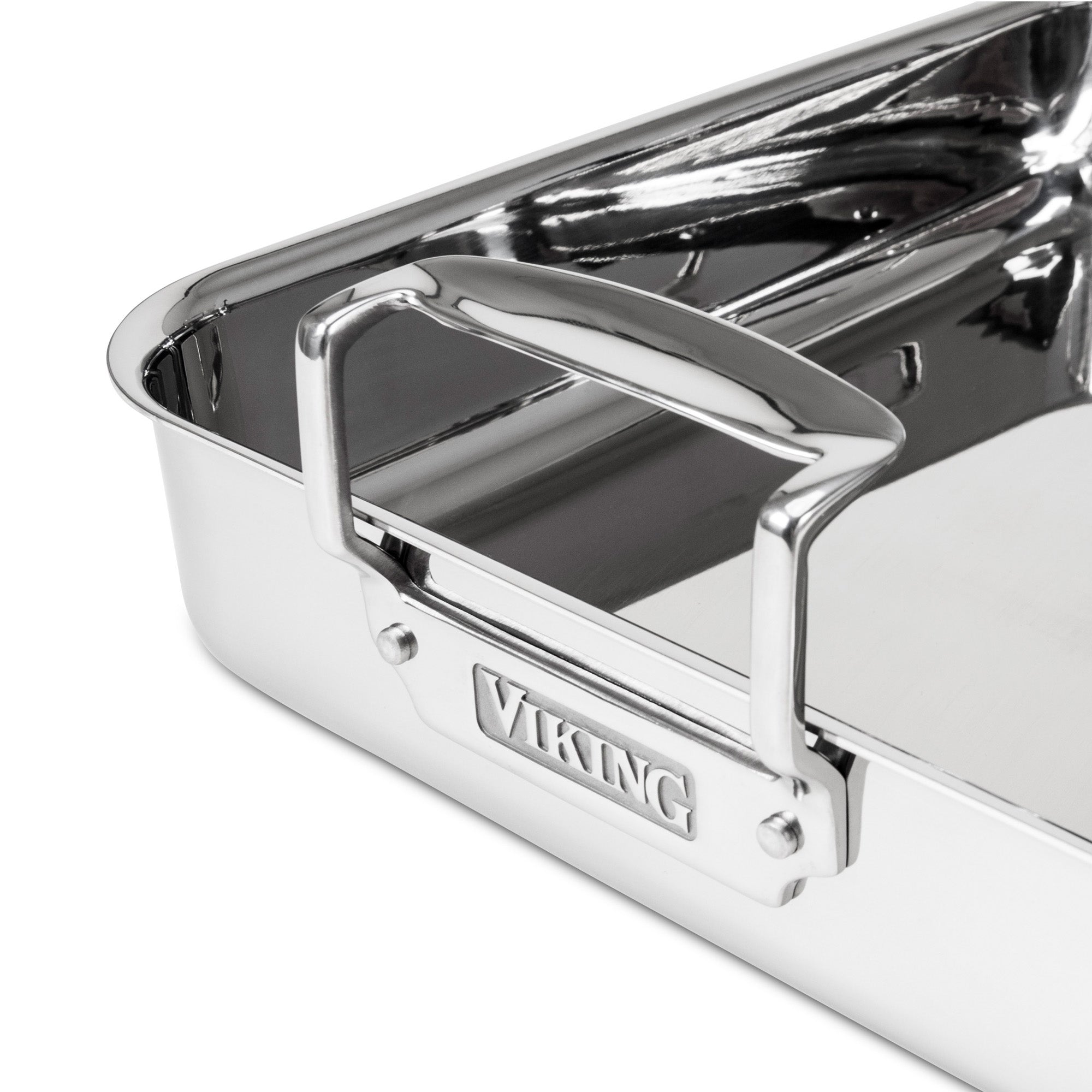 Close-up of the Viking 3-Ply Stainless Steel Roaster with Rack by Viking Culinary Products, featuring sturdy handles, a reflective finish, and an engraved brand name plate. The empty pan includes a nonstick rack for easy roasting.