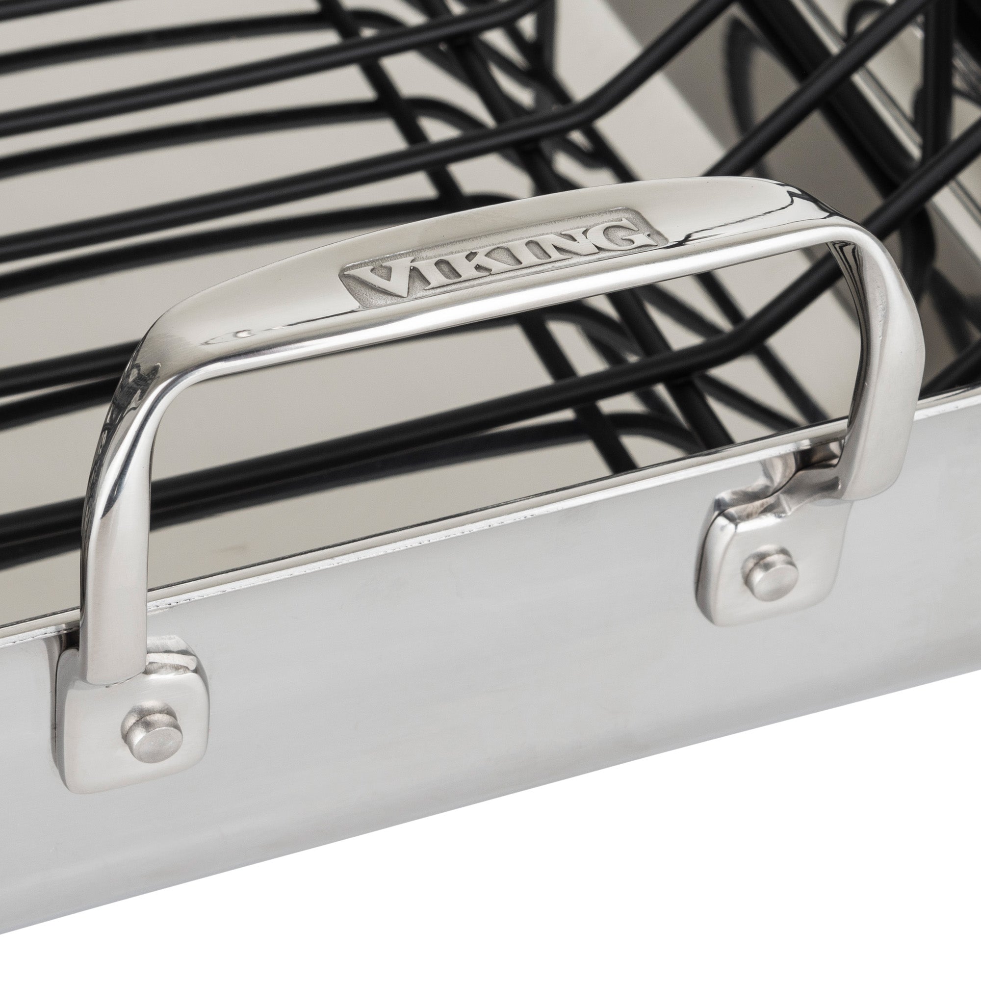 Close-up of the Viking 3-Ply Stainless Steel Roaster with Rack by Viking Culinary Products, featuring a sturdy branded handle and a removable nonstick rack, plus a bonus carving set.