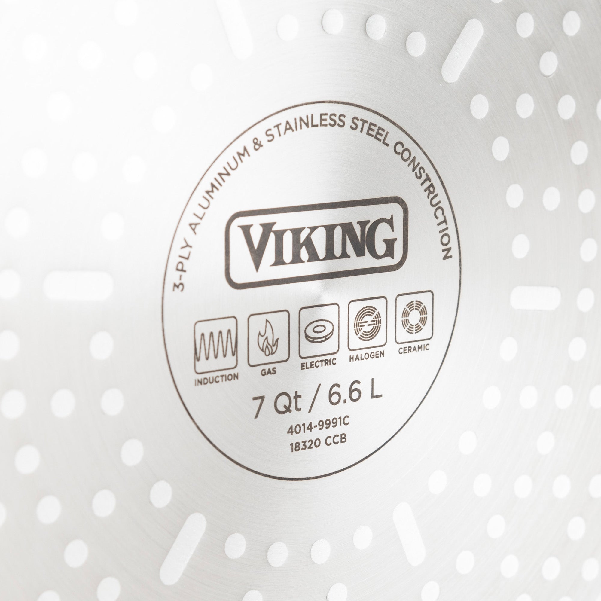 Close-up of the bottom of the Viking Culinary Products 3-Ply Black and Copper 5 Quart Dutch Oven with Glass Lid, showing induction-compatible icons and text highlighting its durable aluminum and stainless steel construction.