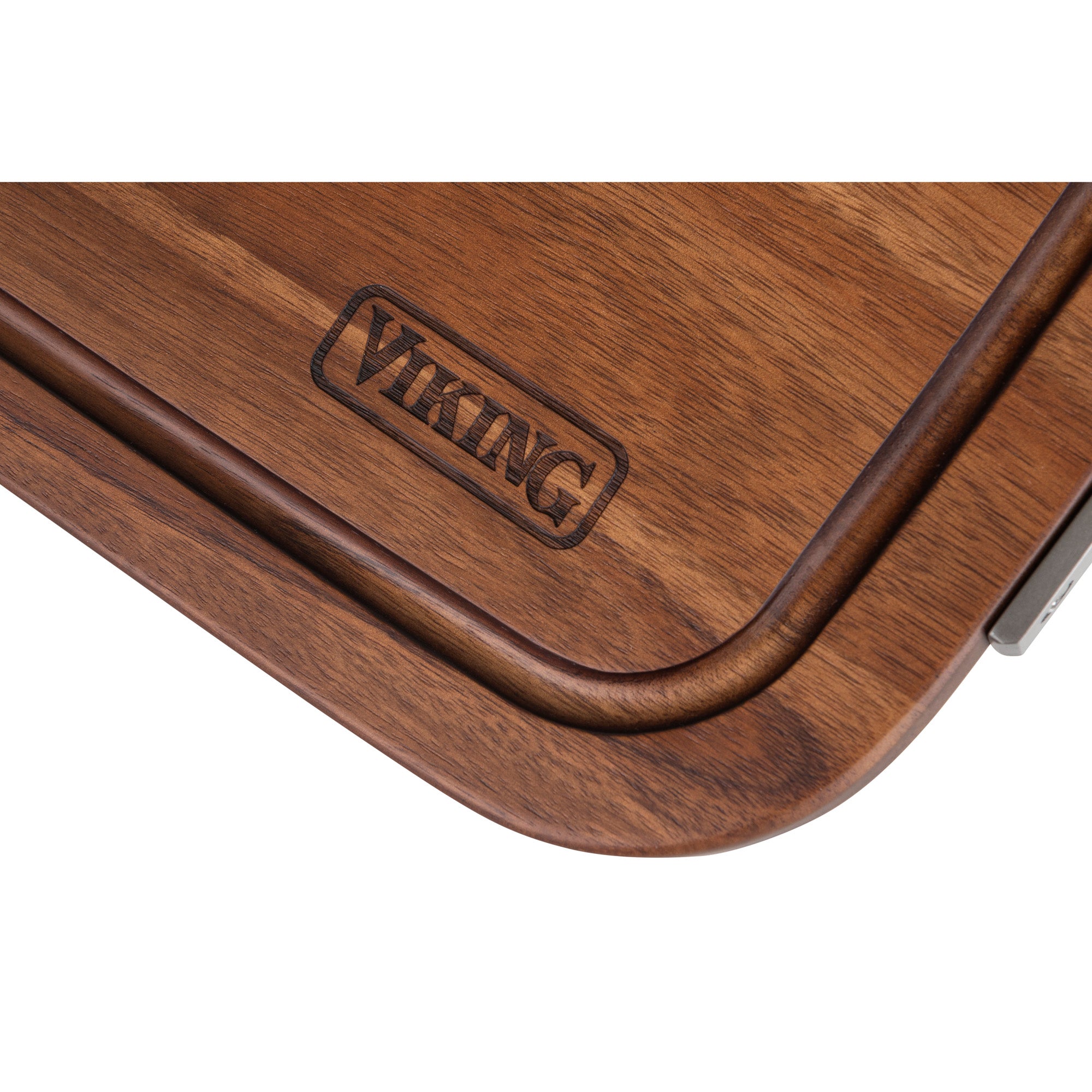 Close-up of the Viking Acacia Carving Board by Viking Culinary Products, featuring rounded edges, a metal handle, engraved logo, and a juice well to catch liquids.
