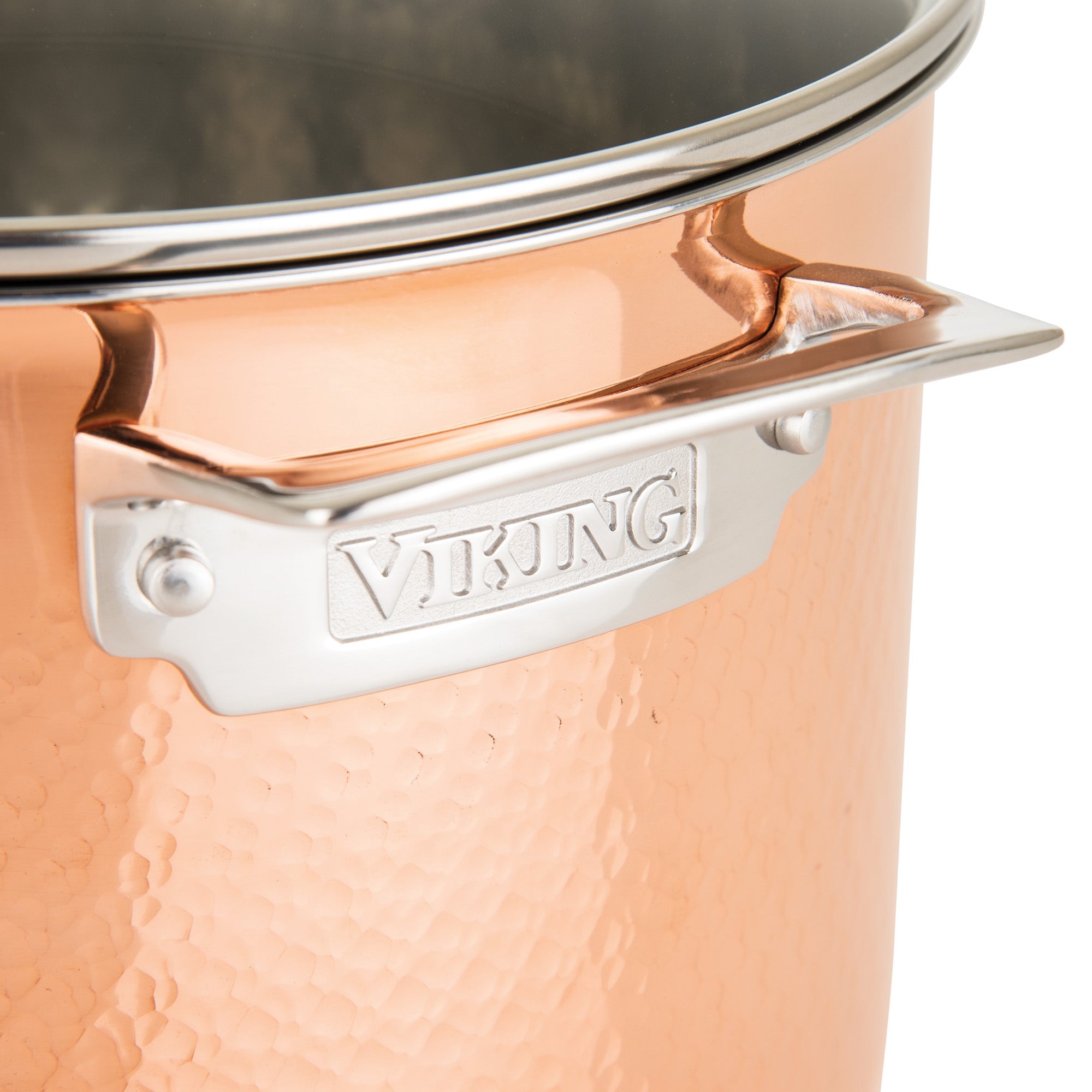 Close-up of a Viking Culinary Products 3-Ply Hammered Copper Clad pot from the 10-piece cookware set, showing its engraved stainless steel handle, stainless steel interior, lid, and rim.