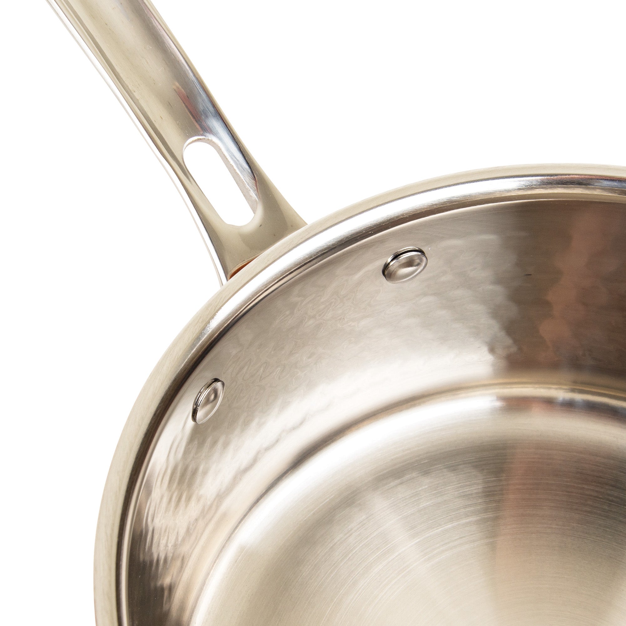 Close-up of the Viking Culinary Products 3-Ply Hammered Copper Clad saucepan, showing its stainless steel interior, sturdy rivets securing the handle, and a portion of the handle with an elongated hole near the base.